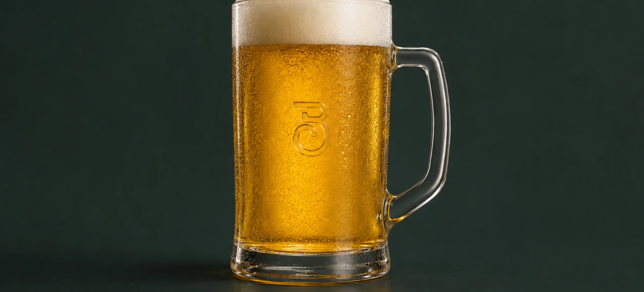 A beer mug with the B monogram etched into the glass