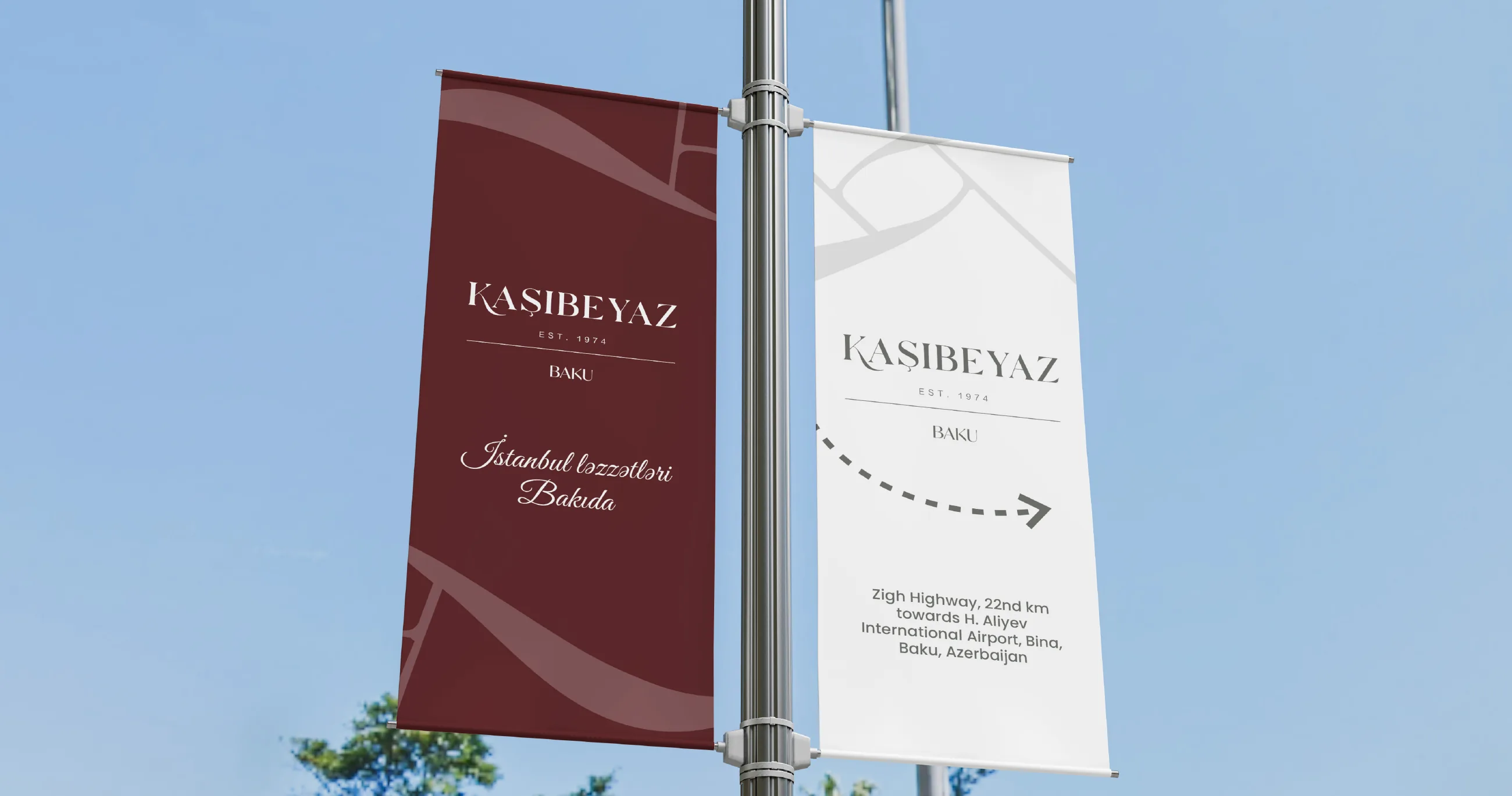 Kaşıbeyaz pole banners in wine red and white against the sky