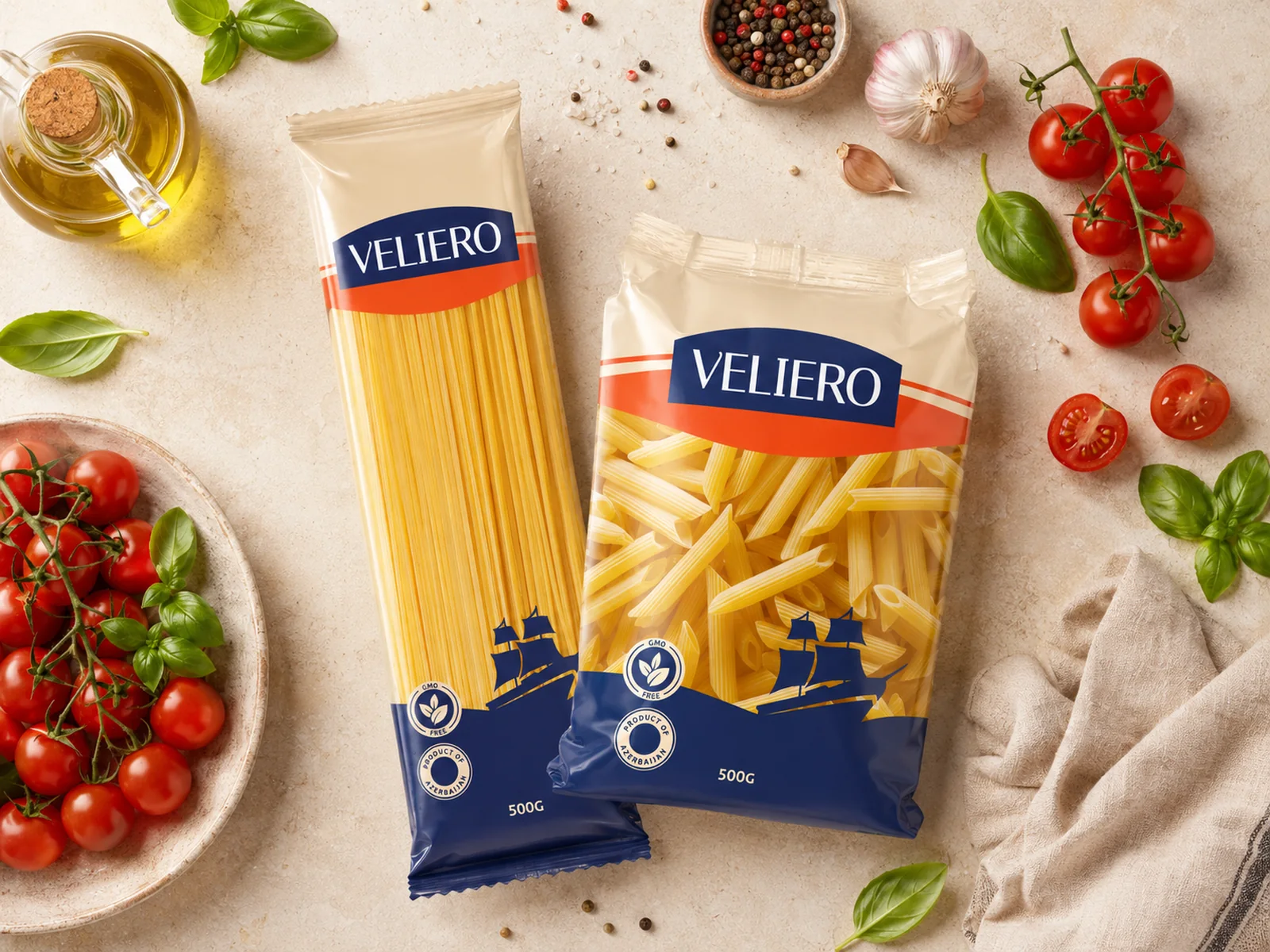 Veliero spaghetti and penne packs among tomatoes, basil and olive oil